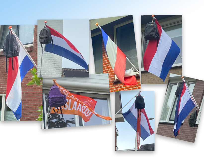 De vlaggen hangen uit voor de geslaagden